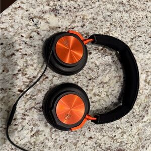 Bang & Olufsen wired over-ear headphones with aluminum ear cups.